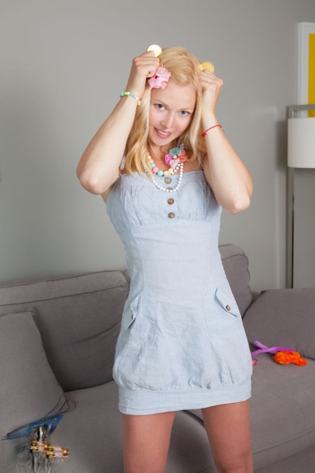 Cute teen Izzy wears a flower in her hair while stripping to striped socks