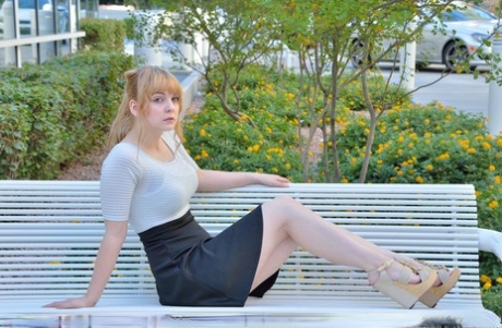 Cute young blonde flashes her big boobs and strolls naked down the street