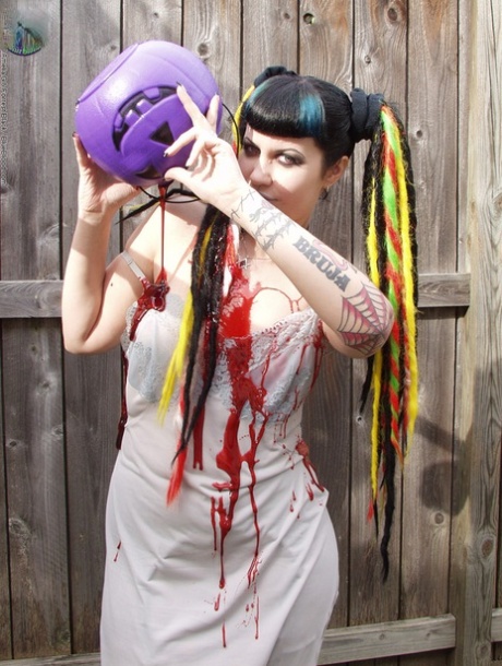 Goth girl Dana Dark pours wax over her natural tits in the backyard