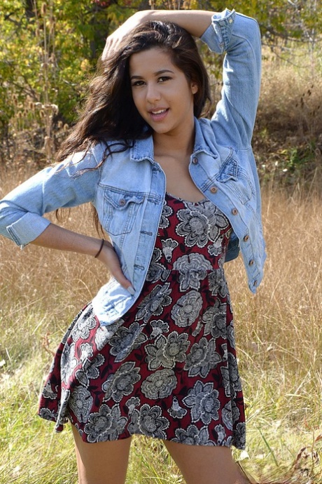 Latina first timer Bella Quinn covers up her exposed boobs in a field