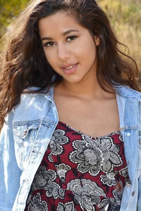 Latina first timer Bella Quinn covers up her exposed boobs in a field