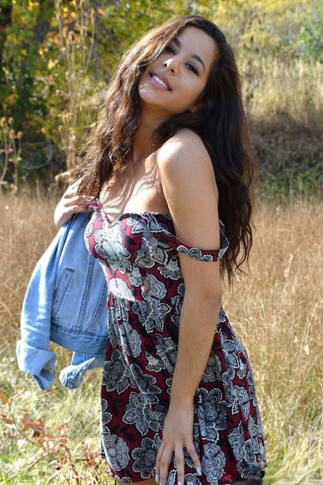 Latina first timer Bella Quinn covers up her exposed boobs in a field