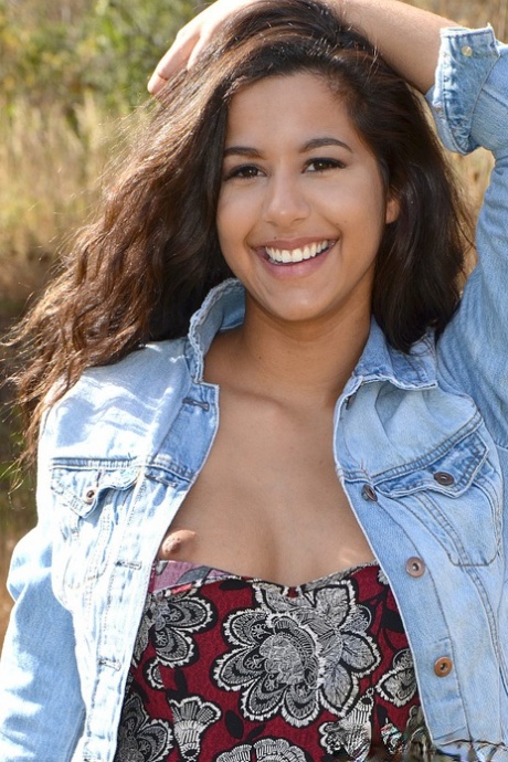 Latina first timer Bella Quinn covers up her exposed boobs in a field