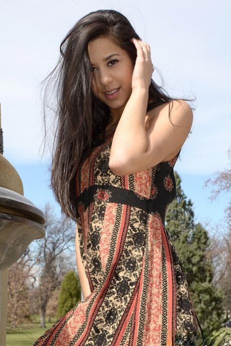 Latina amateur Bella Quinn shows her bare legs in a side split dress
