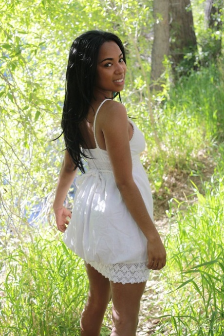 Black beauty Tahela takes off her frock to model naked in the woods