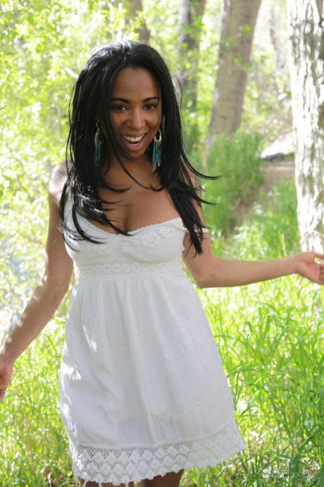 Black beauty Tahela takes off her frock to model naked in the woods