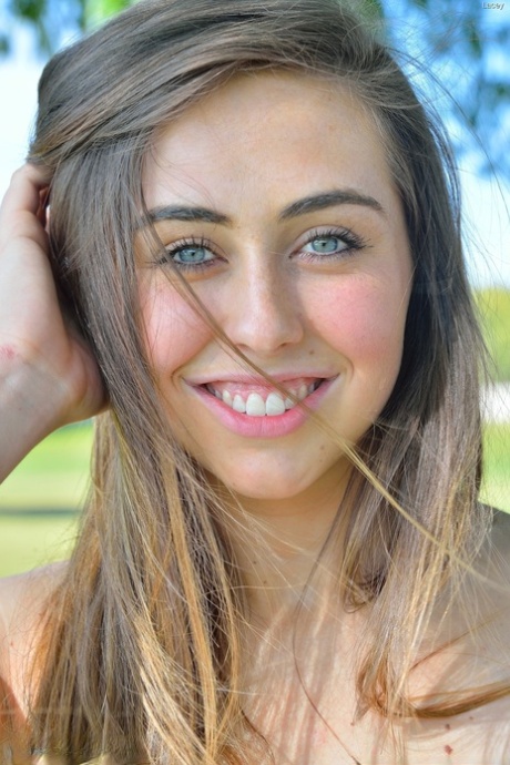 Young solo girl Lacey displays a no panties upskirt in the park