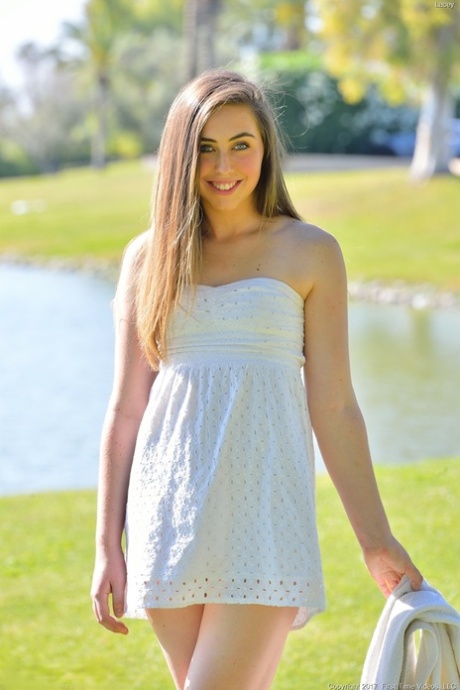 Young solo girl Lacey displays a no panties upskirt in the park
