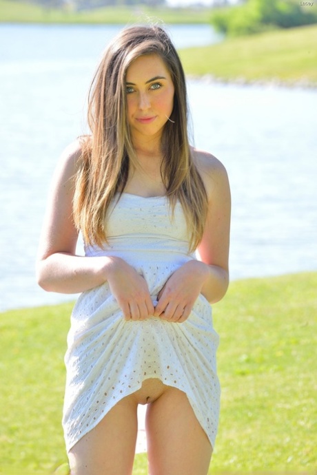 Young solo girl Lacey displays a no panties upskirt in the park