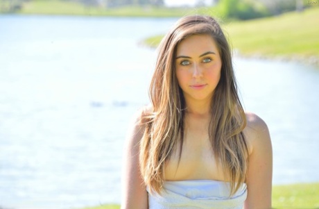 Young solo girl Lacey displays a no panties upskirt in the park