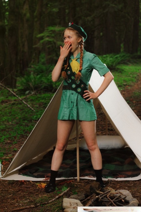 Redheaded Girl Scout Dolly Little gets naked outside her tent in beret