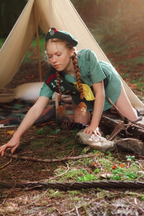 Redheaded Girl Scout Dolly Little gets naked outside her tent in beret