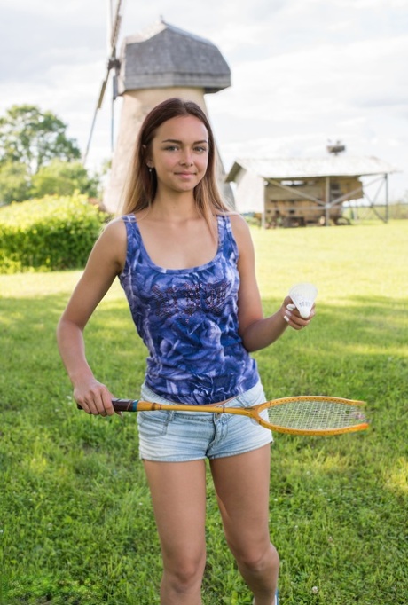 Cute teen Mary gets completely naked on a lawn after playing badminton