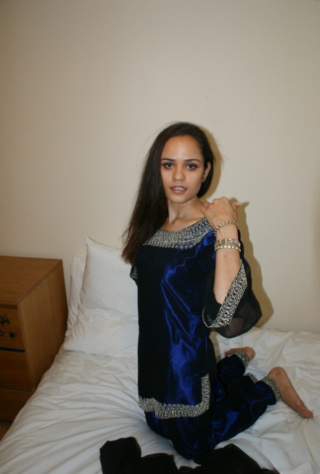 Indian solo girl cups her natural tits on a bed while in her underwear