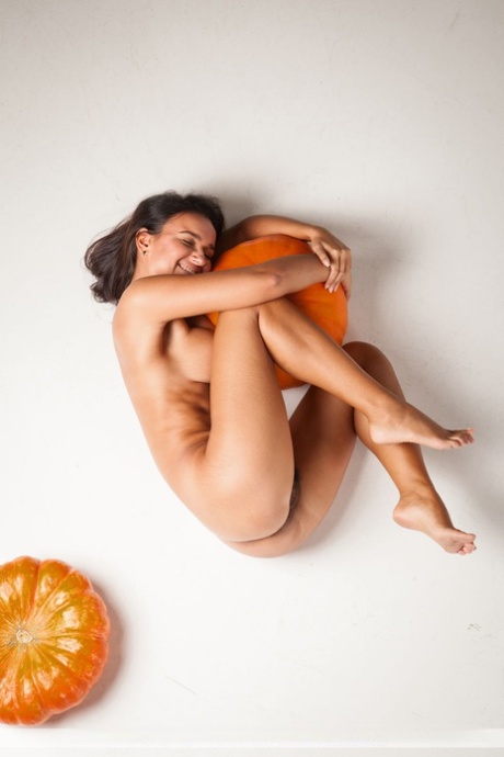 Naked brunette Sanita spreading naked with her pumpkins to show hairy beaver