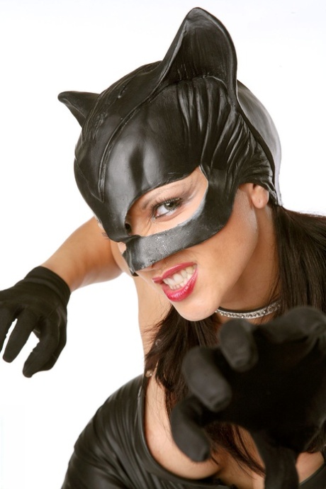 Sexy cosplay MILF Katty in leather catsuit spreading pussy lips wearing gloves
