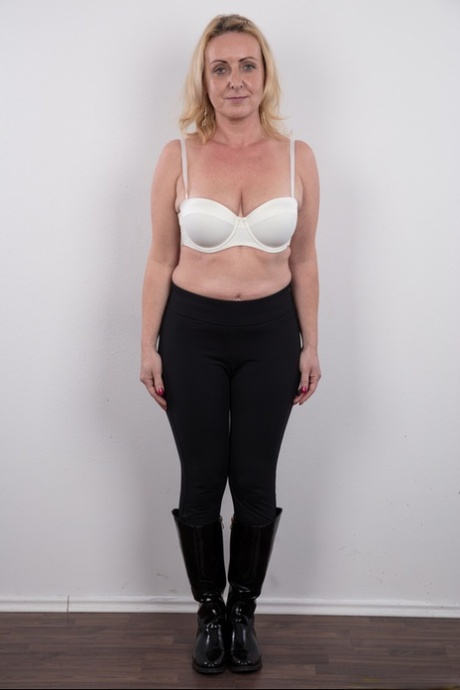 Middle-aged blonde lady Gerlinda stands totally nude after disrobing