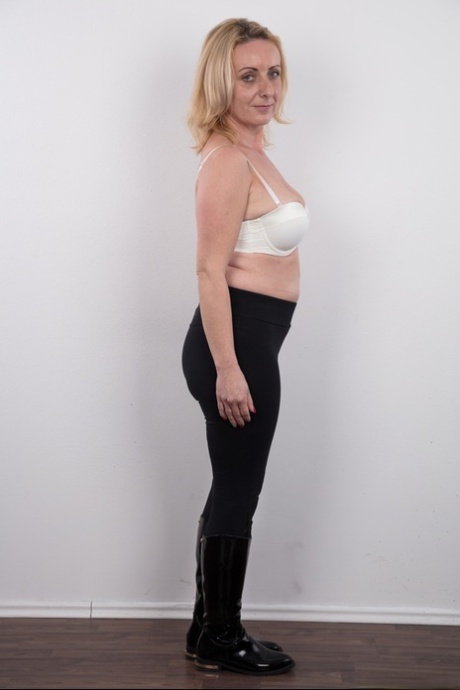 Middle-aged blonde lady Gerlinda stands totally nude after disrobing