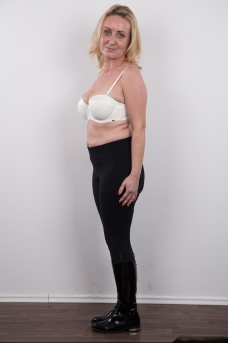 Middle-aged blonde lady Gerlinda stands totally nude after disrobing