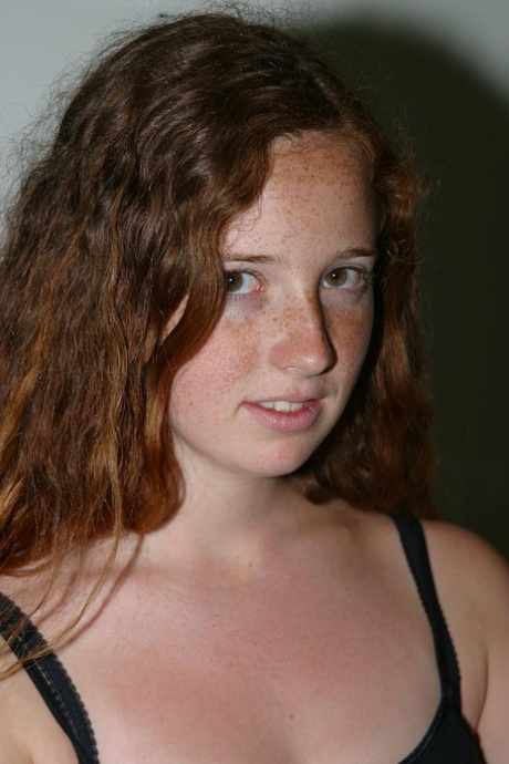 Redhead with freckles and big tits parts her natural pussy after getting naked