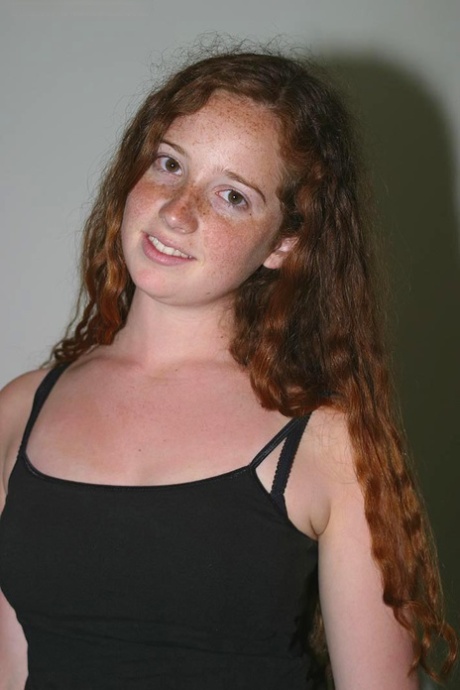 Redhead with freckles and big tits parts her natural pussy after getting naked