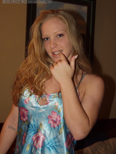 Natural blonde Cali uncovers her firm tits as she she gets totally naked