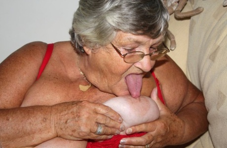 Morbidly obese nan Grandma Libby licks a nipple before spreading her cunt