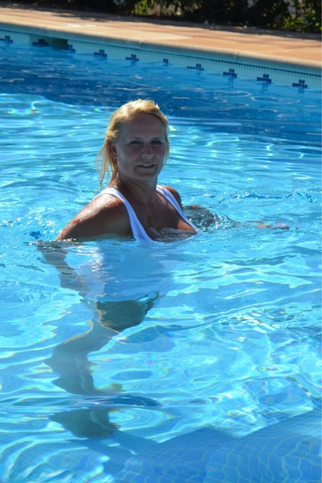 Thick blonde amateur Sweet Susi frees her tits and twat from wet clothing