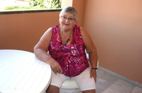 Obese grandmother GrandmaLibby parts her labia lips after disrobing on balcony