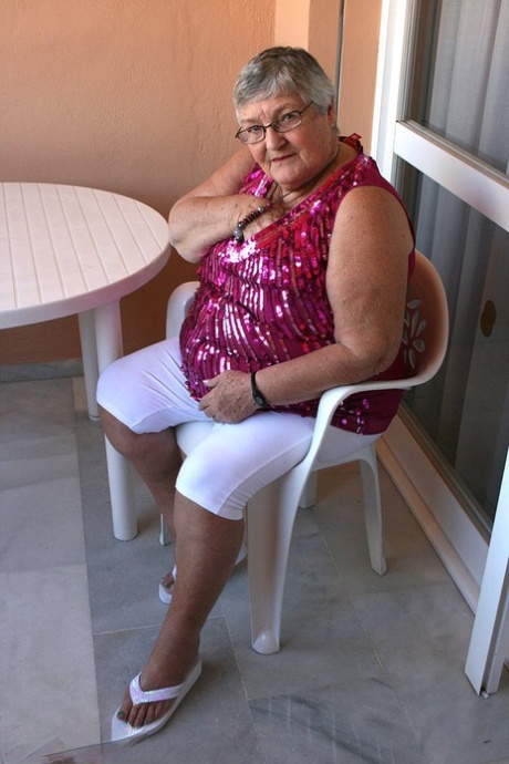 Obese grandmother GrandmaLibby parts her labia lips after disrobing on balcony