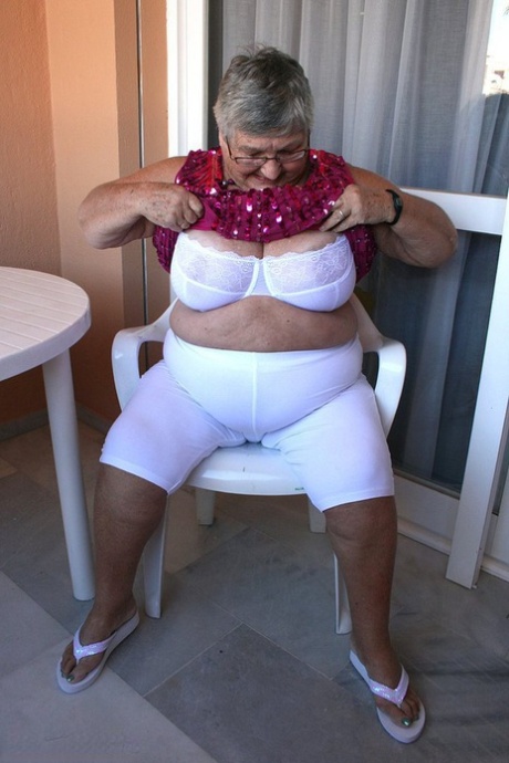 Obese grandmother GrandmaLibby parts her labia lips after disrobing on balcony