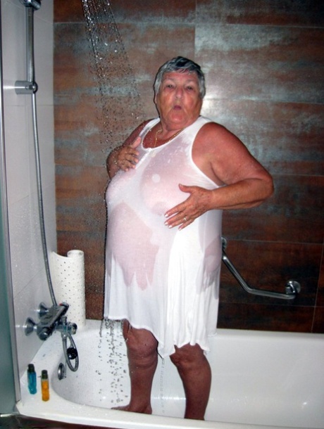 Obese amateur Grandma Libby blow drys her hair after taking a shower