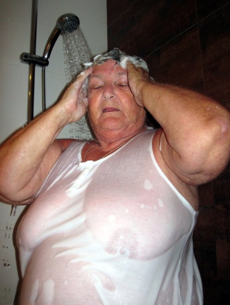 Obese amateur Grandma Libby blow drys her hair after taking a shower