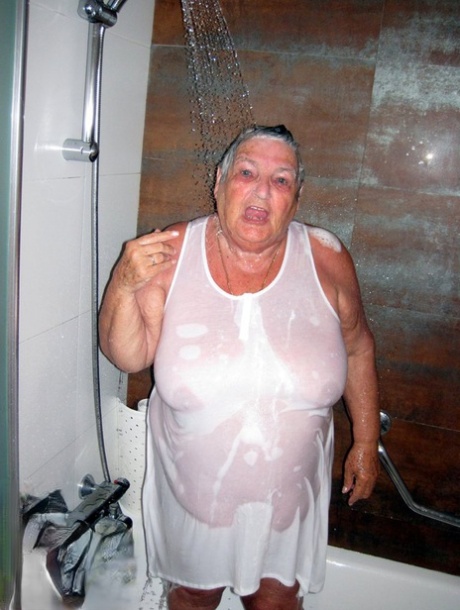 Obese amateur Grandma Libby blow drys her hair after taking a shower