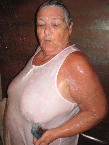 Obese amateur Grandma Libby blow drys her hair after taking a shower