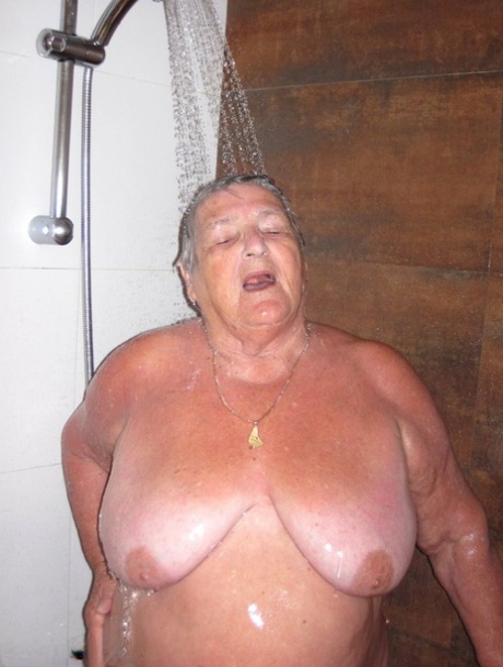 Obese amateur Grandma Libby blow drys her hair after taking a shower