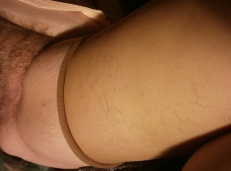 Older amateur Caro plays with her pubic hair during a closeup action