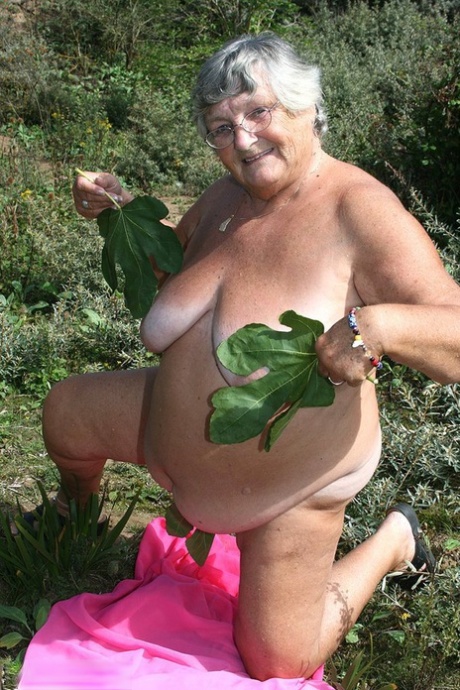 Fat British woman Grandma Libby gets naked on a towel upon scrubby ground