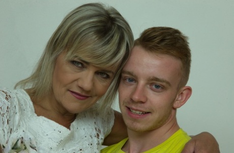 Blonde oma and her toy boy kiss before he strips her and eats her pussy