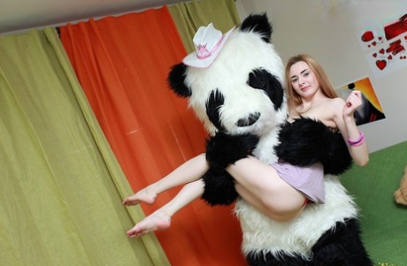 Redheaded teen Tani receives a creampie while having sex with a panda