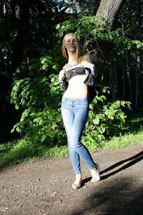 Slim amateur uncovers her small tits in blue jeans during homemade action