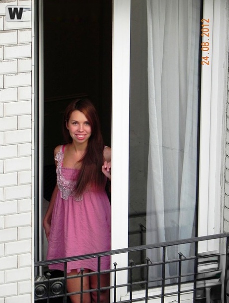 Redhead amateur model Anita flashes tits and ass in pink lingerie