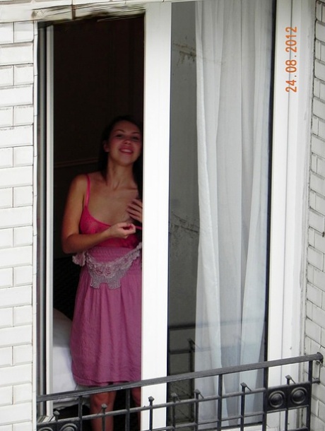 Redhead amateur model Anita flashes tits and ass in pink lingerie