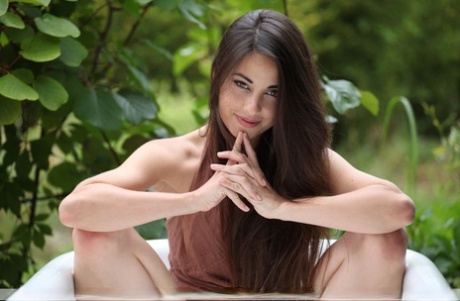 Hot teen Lorena G naked in the garden showing very tiny tits & ass on knees