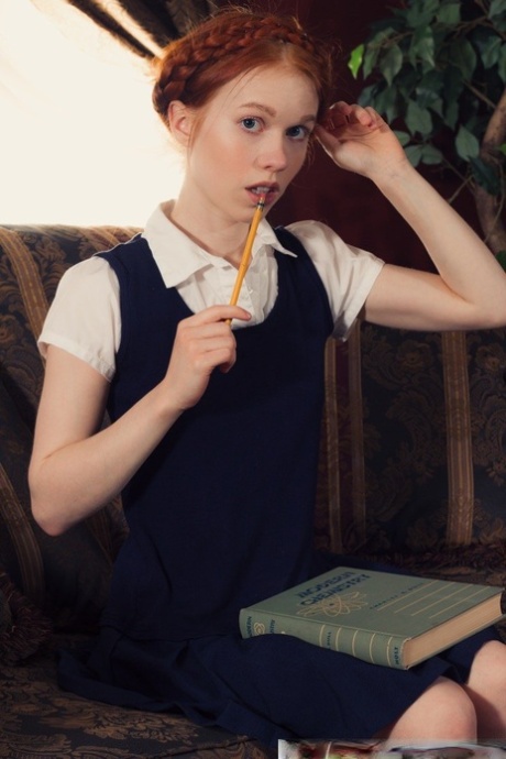 Young looking redhead Dolly Little gets naked in white socks and Mary Jane's
