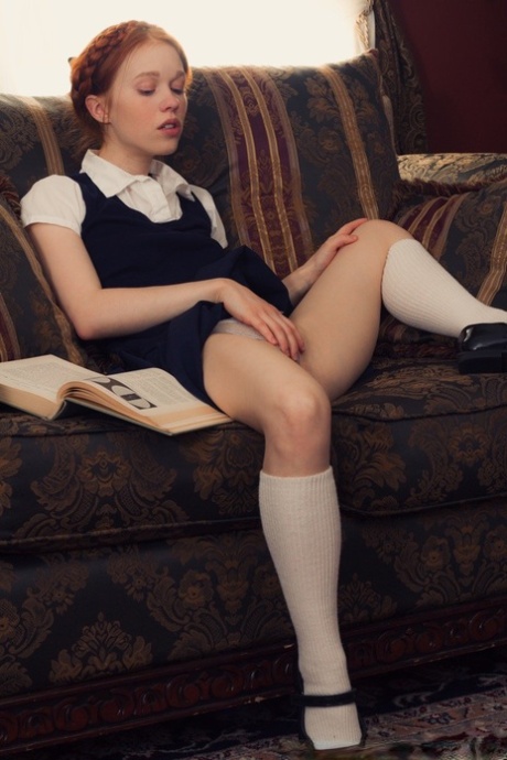 Young looking redhead Dolly Little gets naked in white socks and Mary Jane's