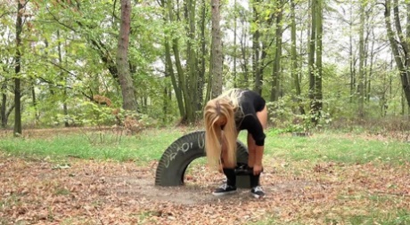 Blonde girl Jenna Lovely takes a pee on leaf strewn ground at a park