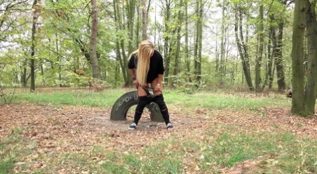 Blonde girl Jenna Lovely takes a pee on leaf strewn ground at a park