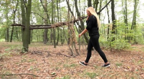 Blonde girl Jenna Lovely takes a pee on leaf strewn ground at a park