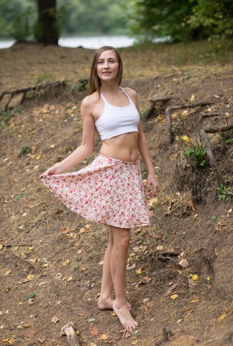Nice teen Alexandra F gets completely naked while in a forest